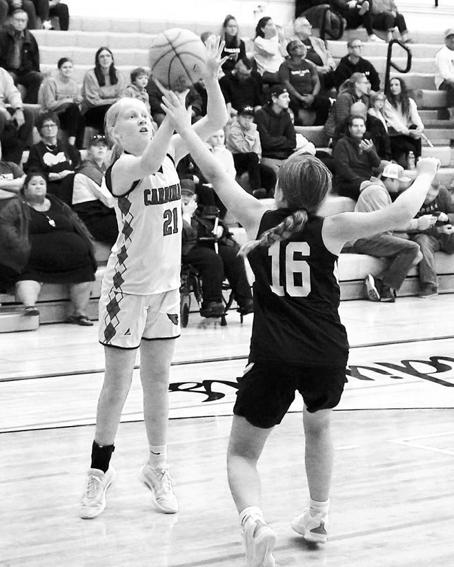 Charlotte Haaven adds two points to the Cards' score in their win over the Eagles. Photo by Larry Stokke.