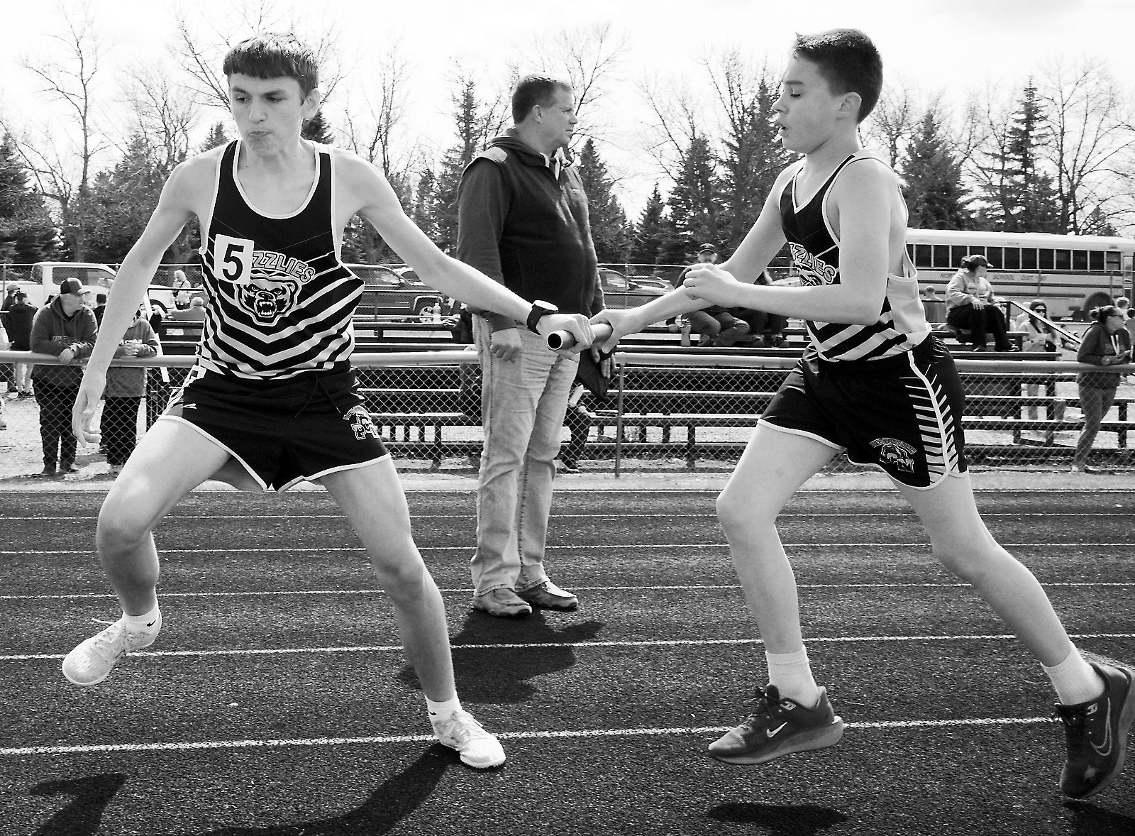 Logan Thompson hands off the baton to Connor O'Hara in the 4X800 relay. Photo by Larry Stokke.