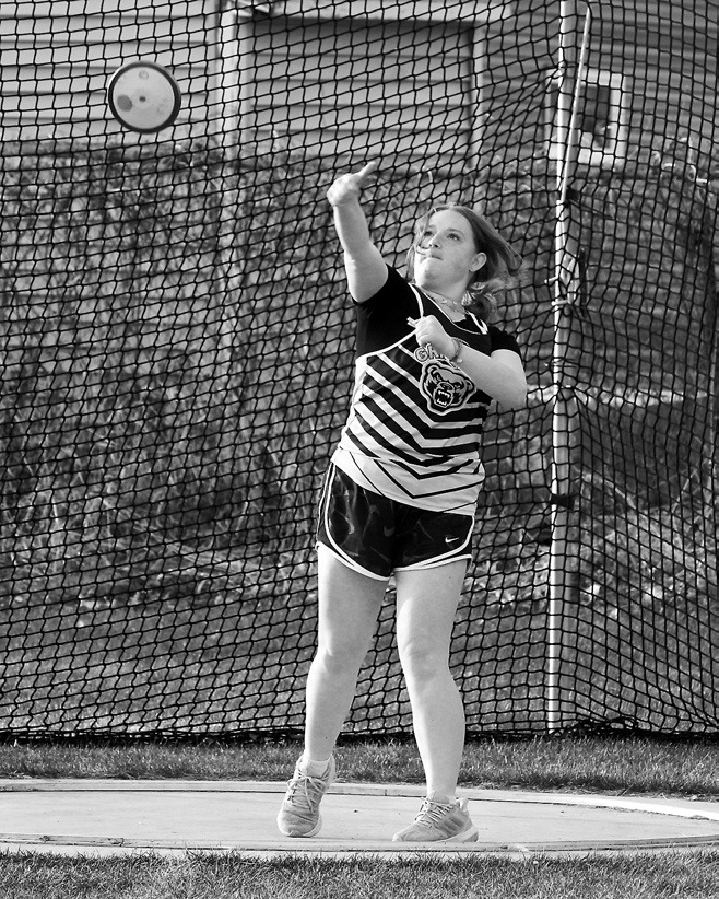 Grace Follin launches the discus at the Langdon Invitational Track Meet. Photo by Larry Stokke.