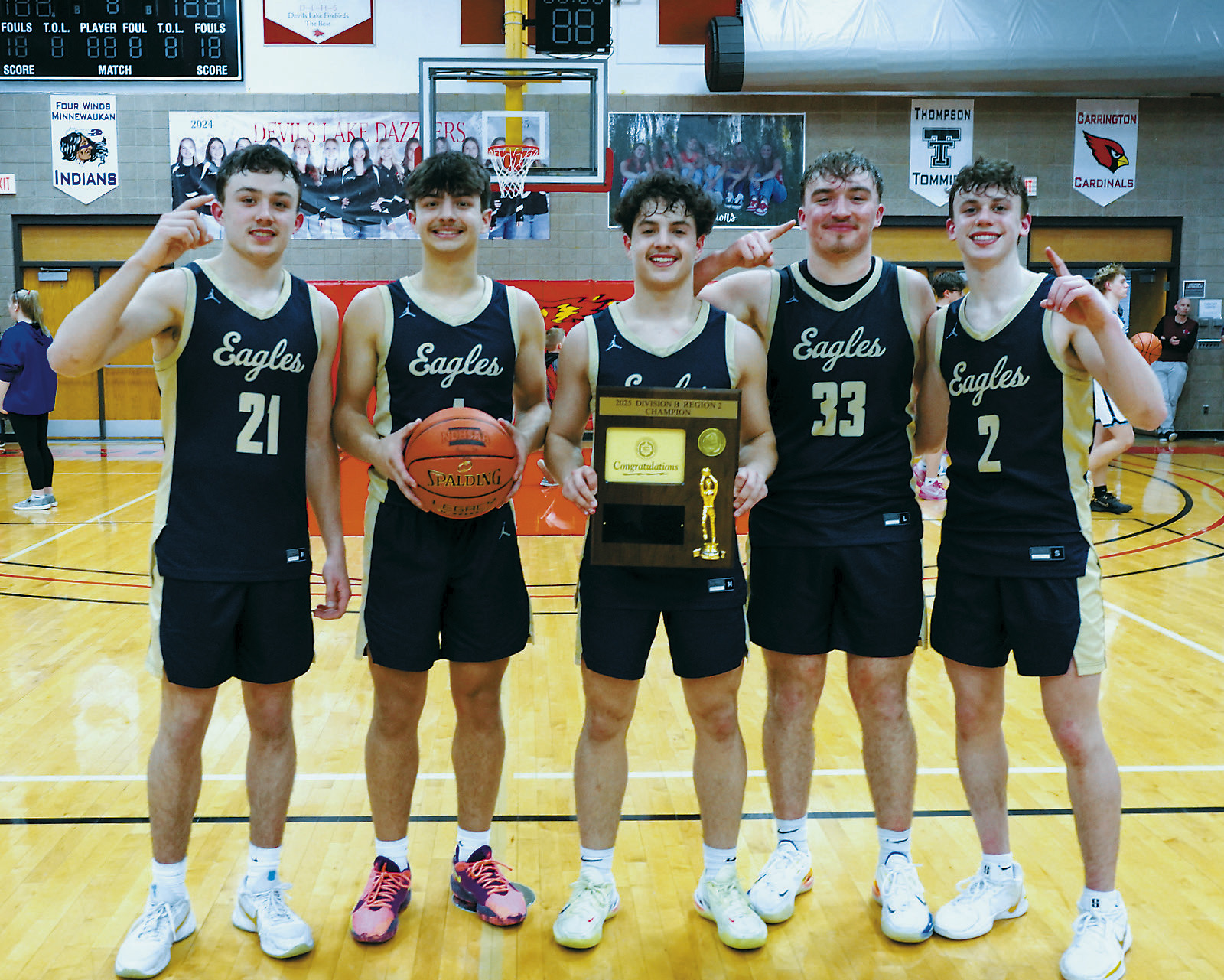 From (L-R) Brody Berg, Weston Cosley, Grant Cosley, Kade Schafer, and Kaden Moore celebrate with the game ball and plaque after winning the Region 2B Championship. Photo by Larry Stokke.