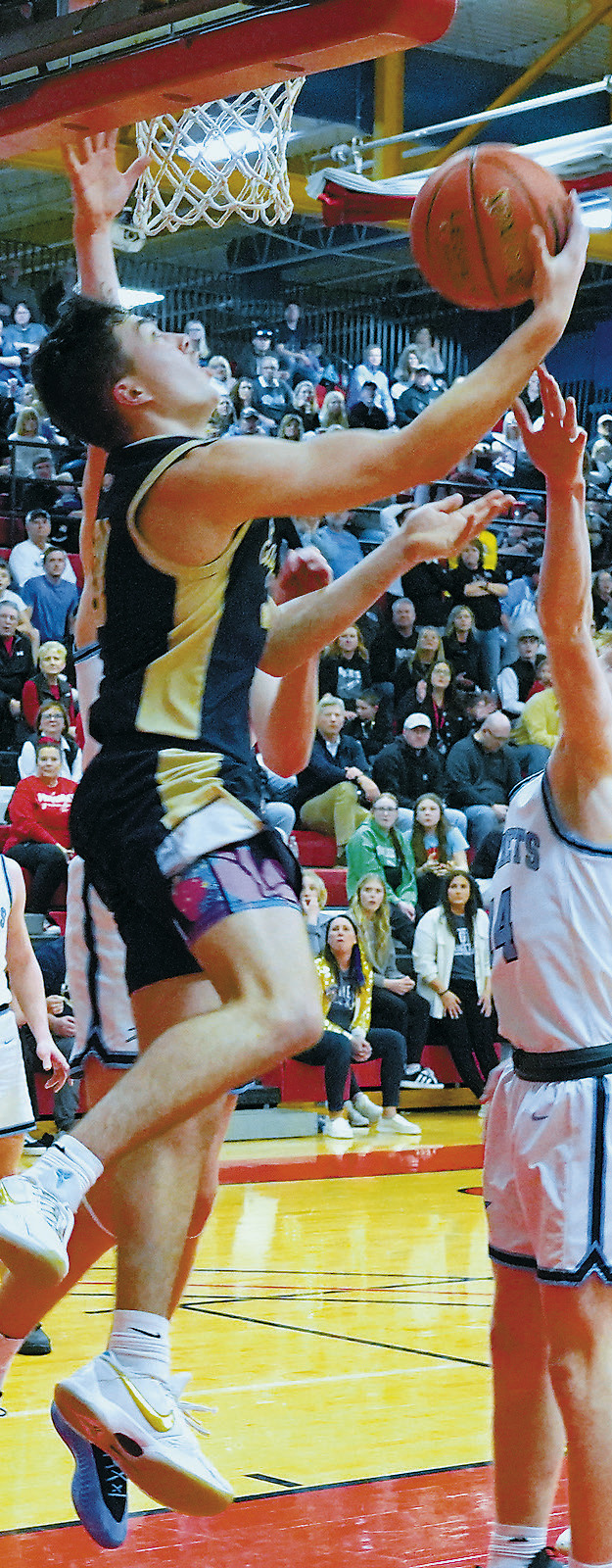 Brody Berg drops in a reverse lay-up and added 11 points to the Eagles' win over the Rockets in the Region 2B Tournament. Photo by Larry Stokke.