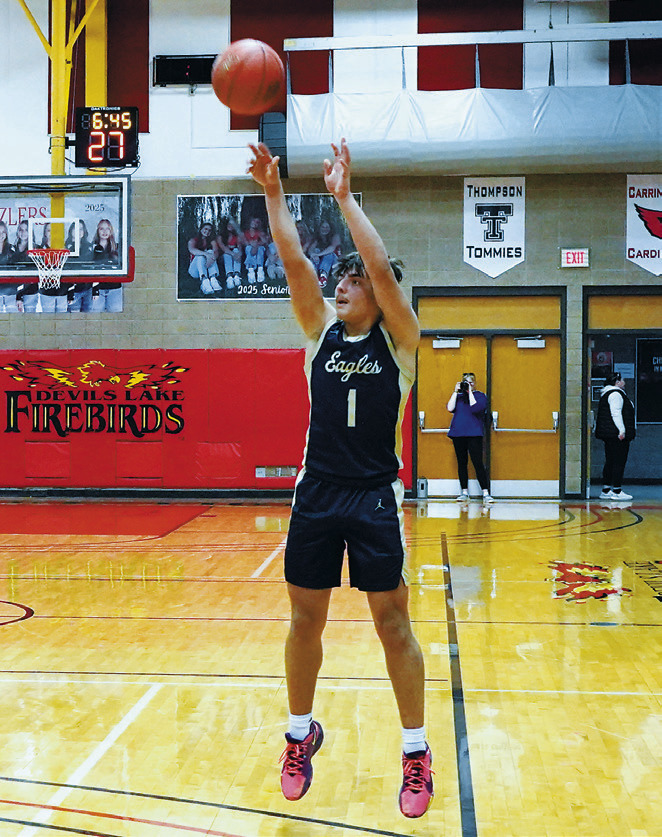 Weston Cosley drains one of his 3-point baskets, finishing the championship game with 10 points. Photo by Larry Stokke.