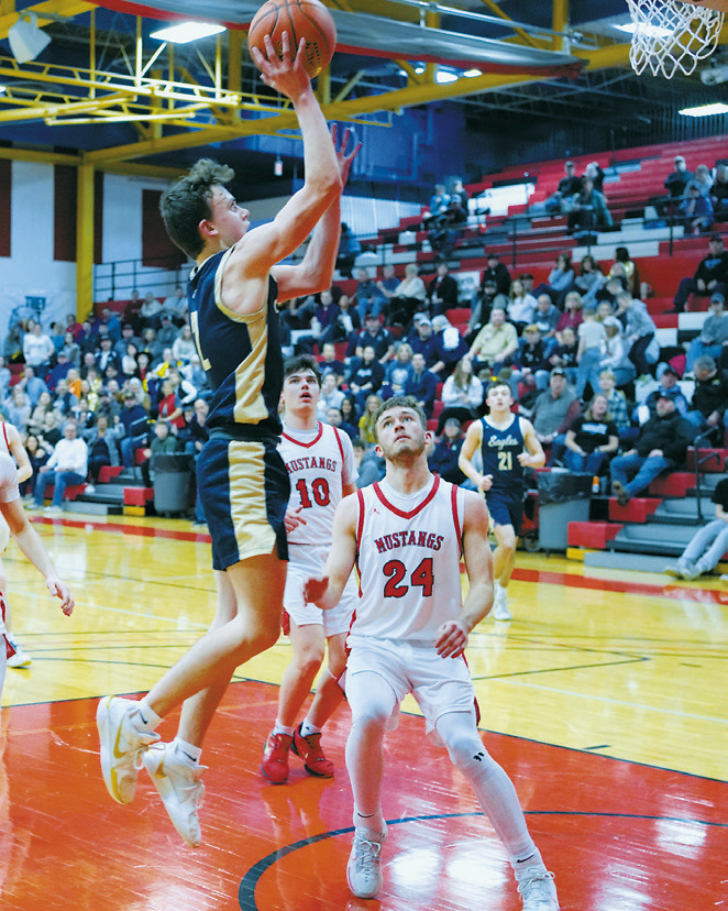 Kaden Moore lays in a basket during the semifinal win over the Mustangs, finishing the game with 16 points. Photo by Larry Stokke.