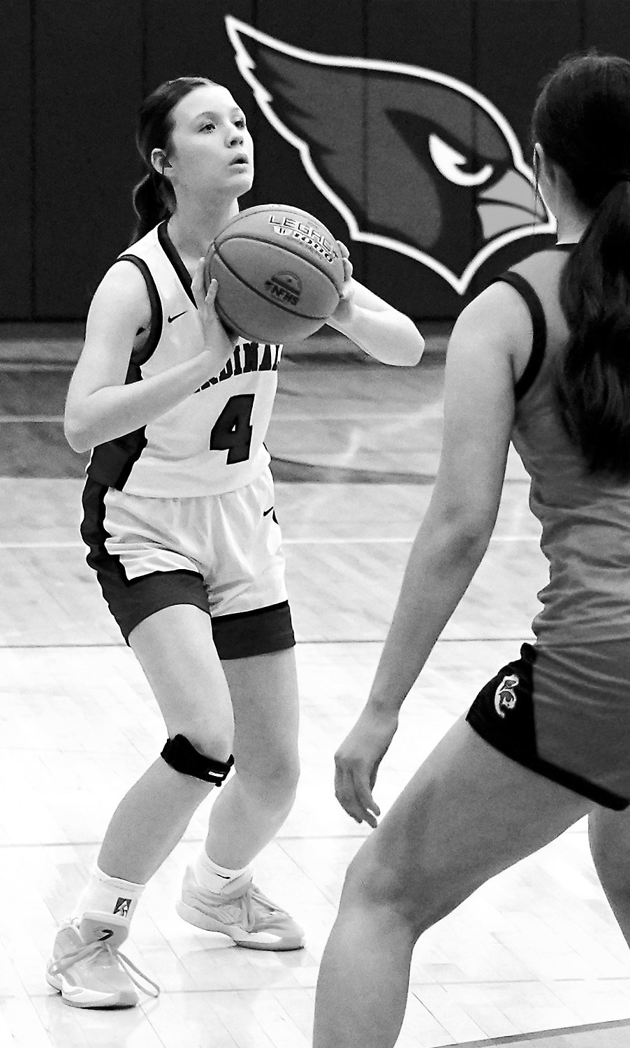 Maci Gage with a defender in front of her drains a three-pointer in the closing minutes of the 4th quarter in the game against Central Cass. Photo by Larry Stokke.