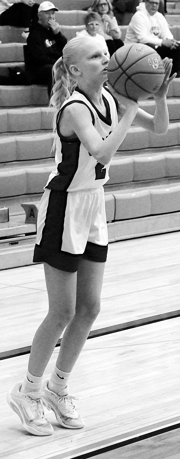 Taya Feist drives into the lane and adds two points to the Cards' score. Photo by Larry Stokke. Mya Swanson eyes the basket and fires off a shot. Photo by Larry Stokke.