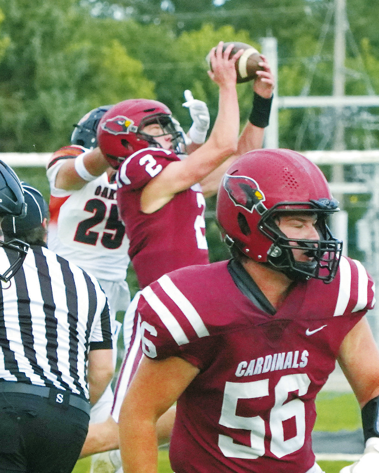 Jax Johnson intercepts a pass to an Oakes player in the first quarter, setting the Cardinals up for their first touchdown. Photo by Larry Stokke.