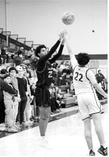 Shaun Kelso fires off a three-point shot against the Spoilers in Grafton Feb 20th. Photo by Larry Stokke