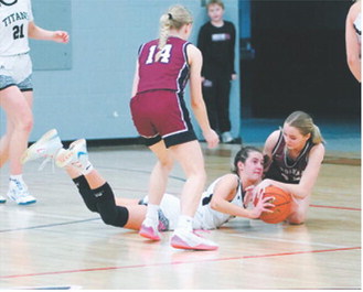 DVE player of the game Jaelyn Johnson finished the night with 10 points. Here she is fighting for possession of the loose ball with Hallie Overby. Photo by Larry Stokke