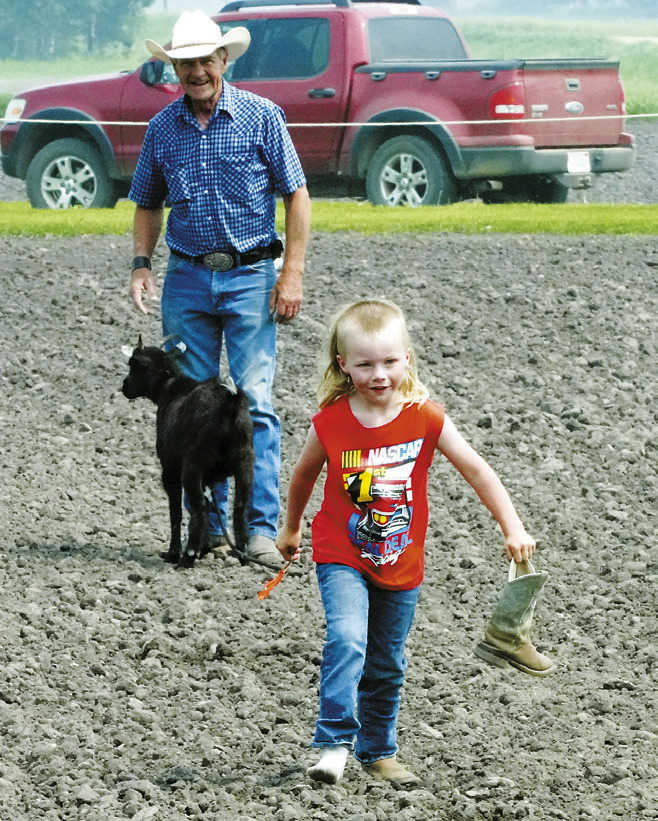 Mickane Halverson lost a boot on the way back to the finish line after taking the ribbon off of the Kevin during the 'goat undecorating' event. Photo by Larry Stokke.