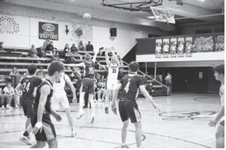 Kade Schafer launches a shot outside the 3-point line. Photo by Ashley Schafer.