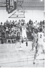 Brody Berg grabs the rebound. Photo by Ashley Schafer.