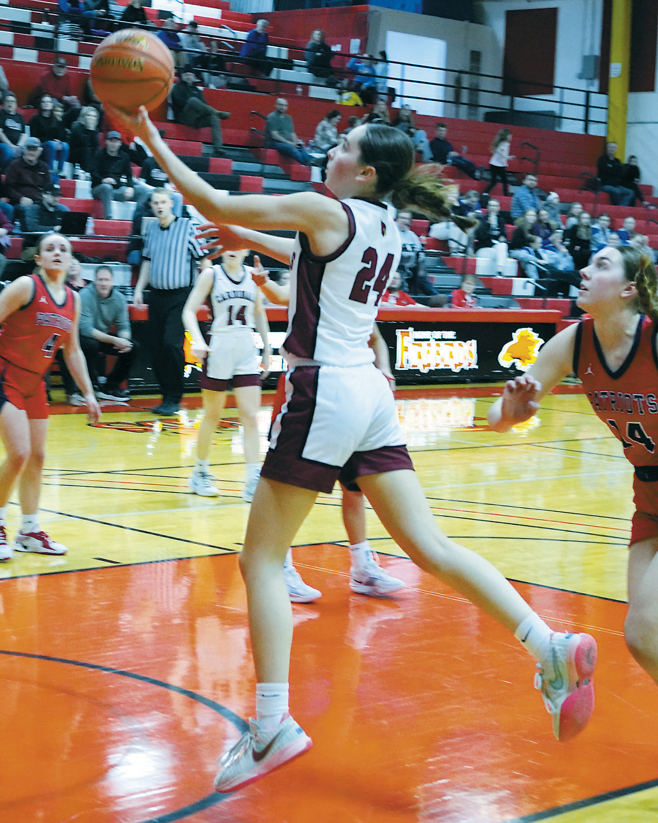 Avery Lorenz with a finger tip roll into the basket adds two points to the Cards' winning score. Photo by Larry Stokke.