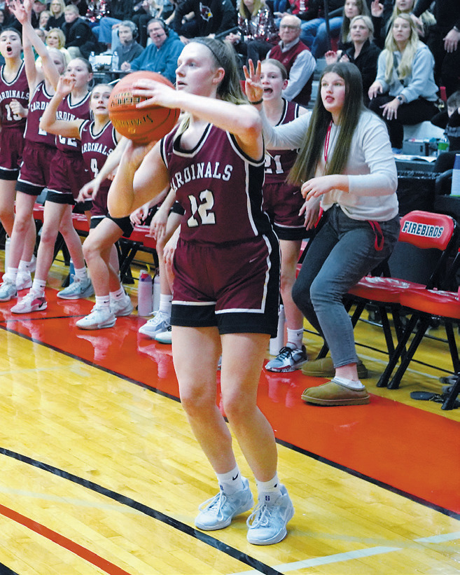 Mikaela Olson puts up a 3-point shot in front of the Cardinal bench. Photo by Larry Stokke.