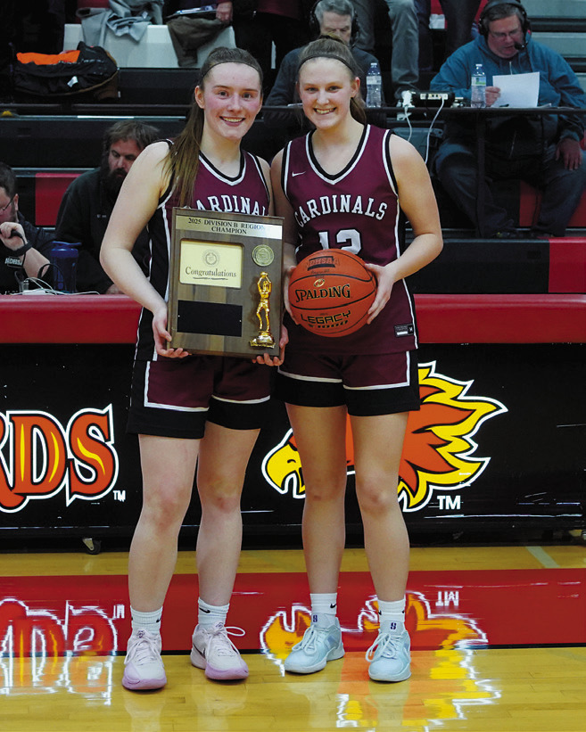 Meredith Romfo and Mikaela Olson with the 1st place plaque and game ball. Photo by Larry Stokke.