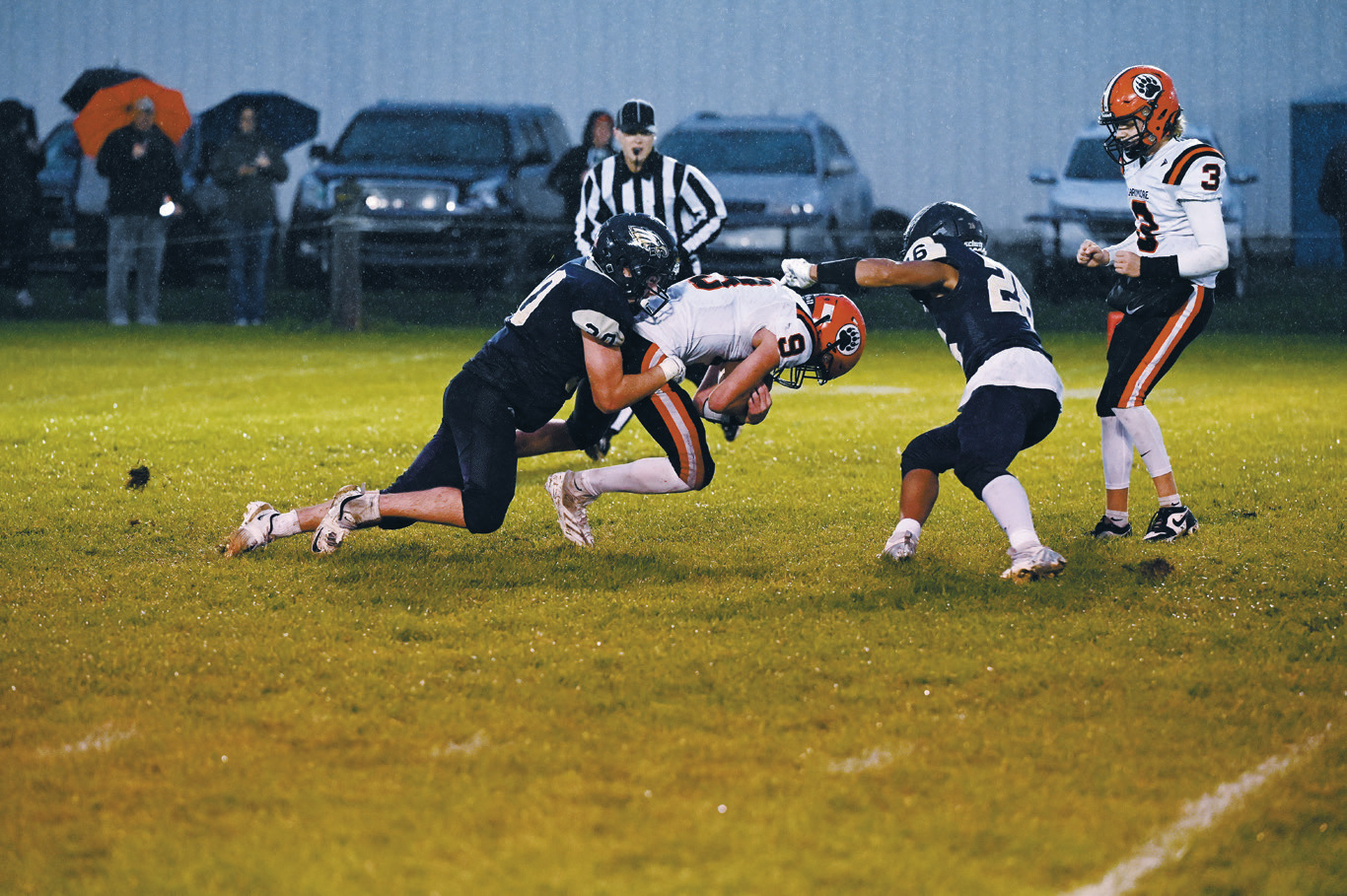 A strong defensive effort from Brody Berg and Trevor Moore as they halt the run. Photo by Ashley Schafer.