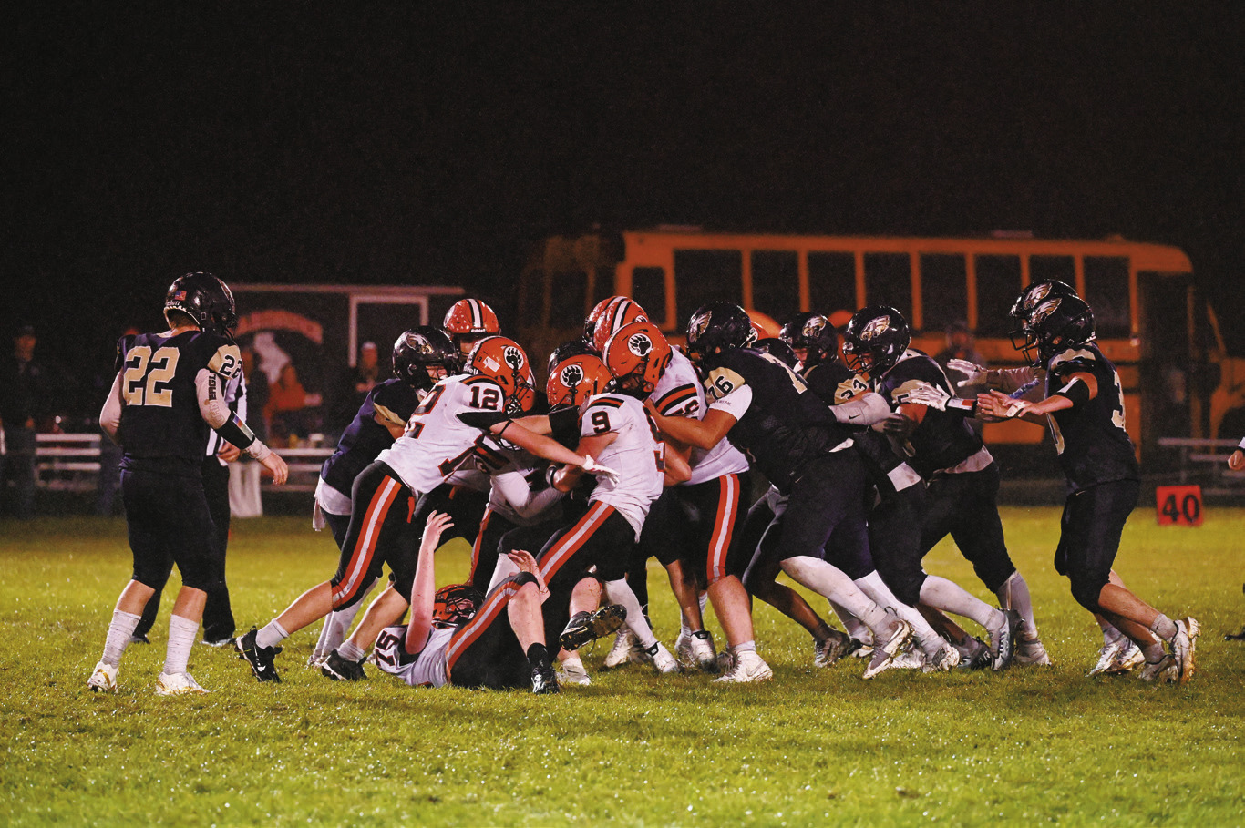 Stacked at the line — defenders swarm to shut down the play. Photo by Ashley Schafer.