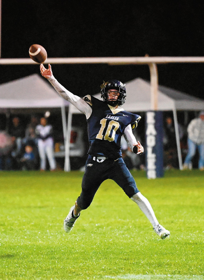 Kaden Moore drops back and fires a pass downfield. Photo by Ashley Schafer.