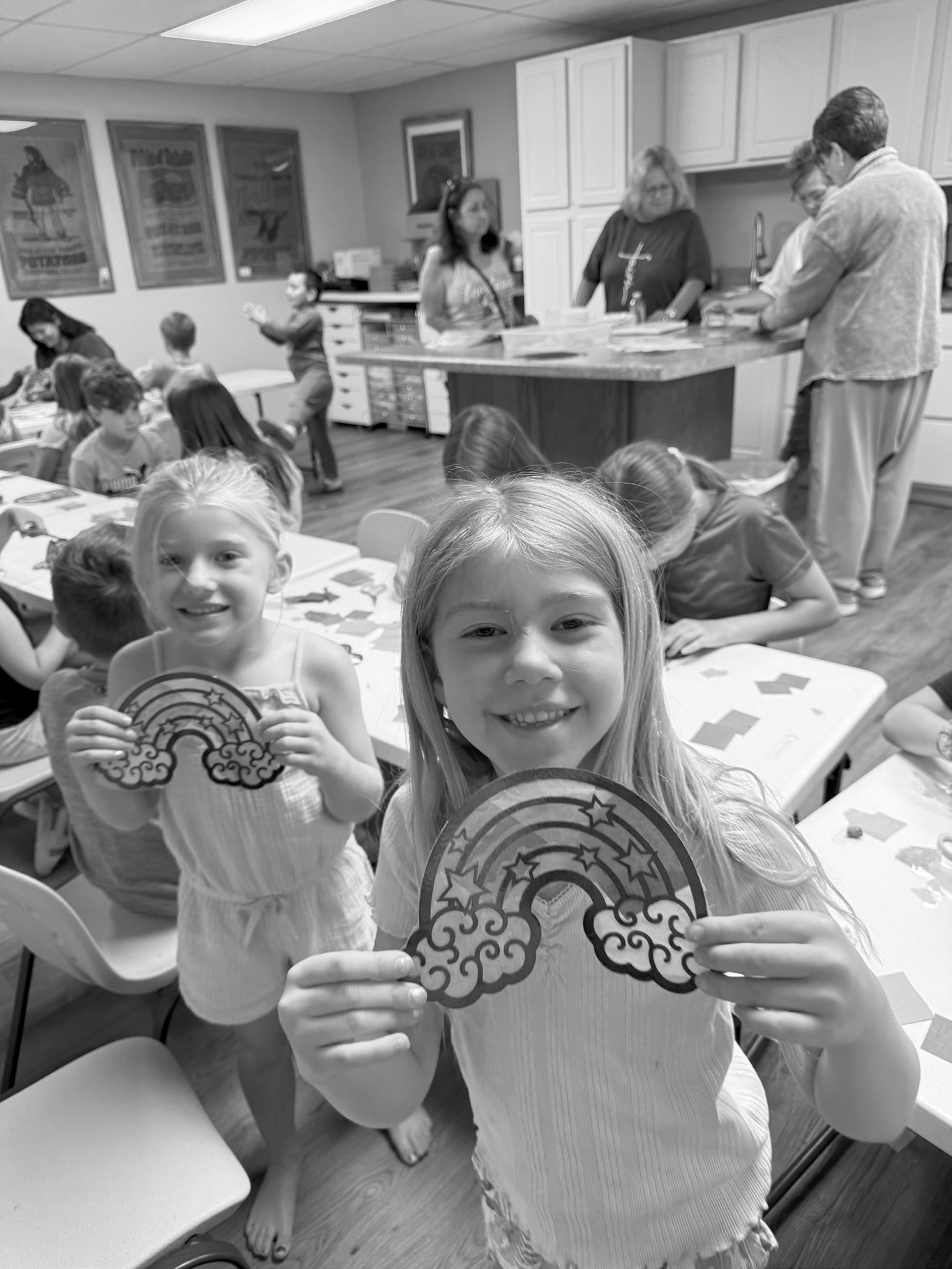 Raylee and Ramsey Trupe show off their stained glass pictures they created during story hour.