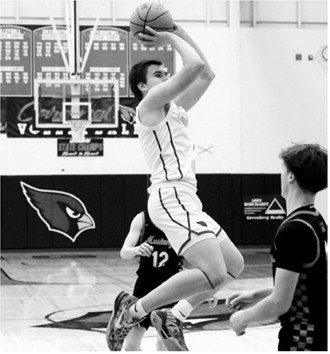 Eastyn Schaefer elevates and drops the ball in the basket. He had a 24-point game against the Midway-Minto Mustangs. Photo by Larry Stokke