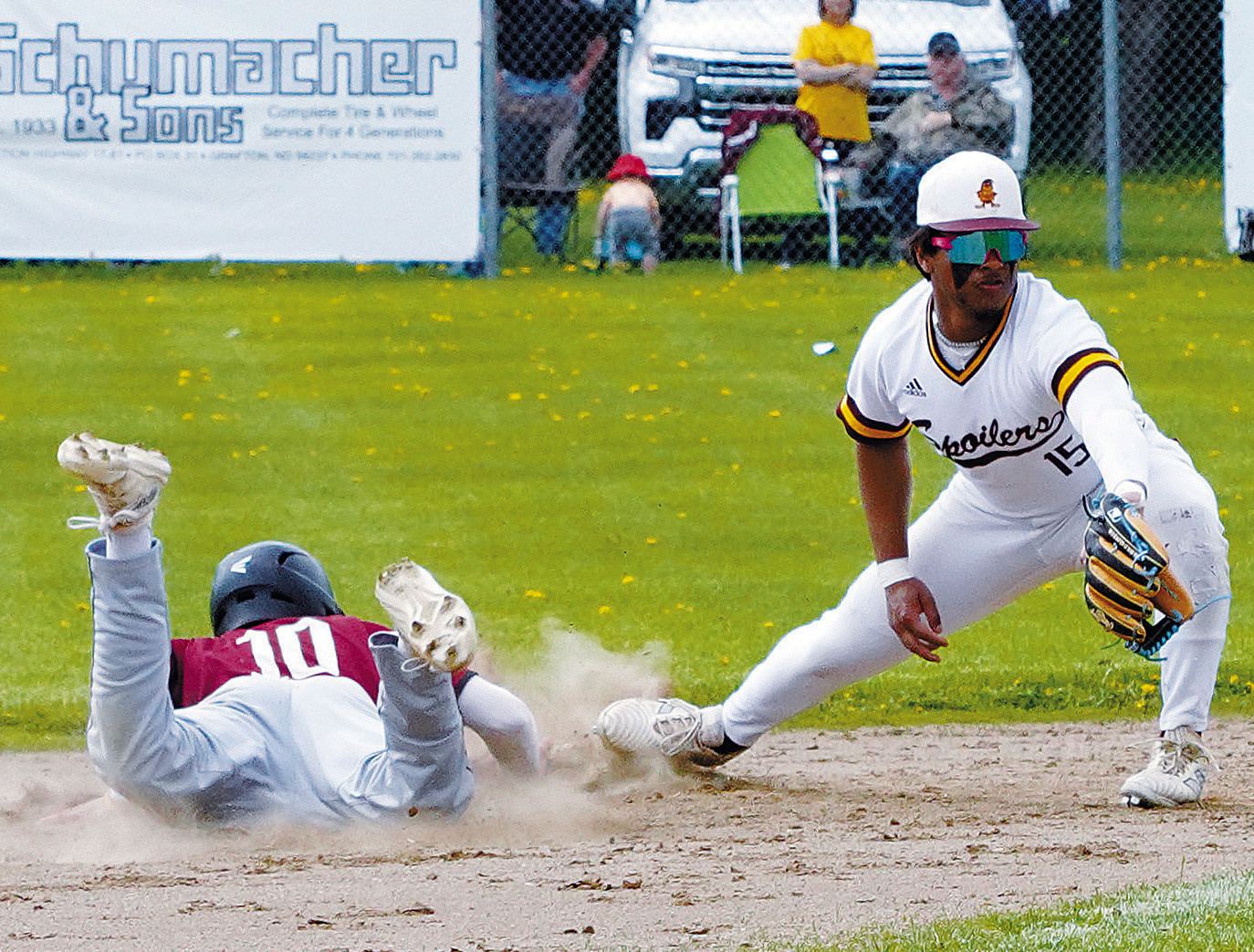 Mason Romfo dives back to first base safely. Photo by Larry Stokke.