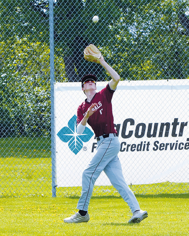 Kadyn Hein catches a hard hit ball in right field close to the fence against Grafton. Photo by Larry Stokke.