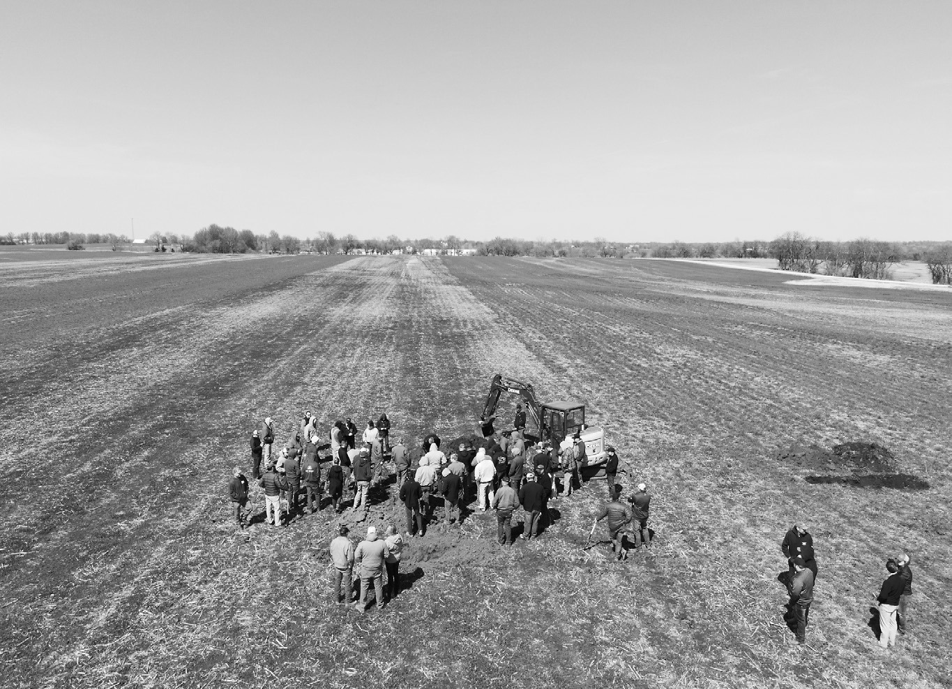 Farmers view a soil pit as part of an on-farm soil health research project. (NDSU photo)