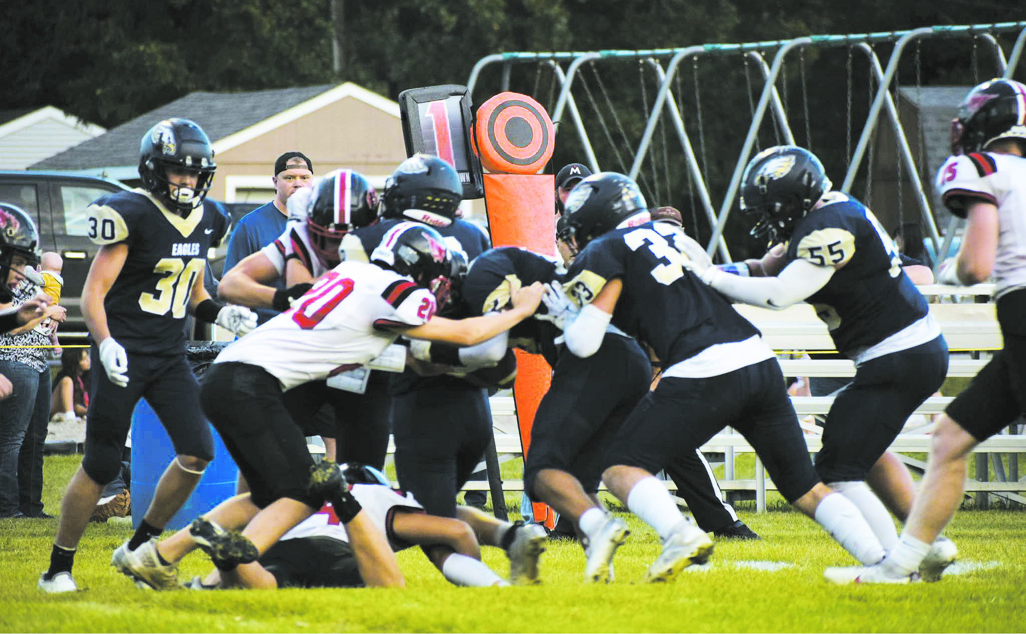 The Eagles drive through as their opponents attempt to tackle the ball runner. Photo by Rebecca Davis.