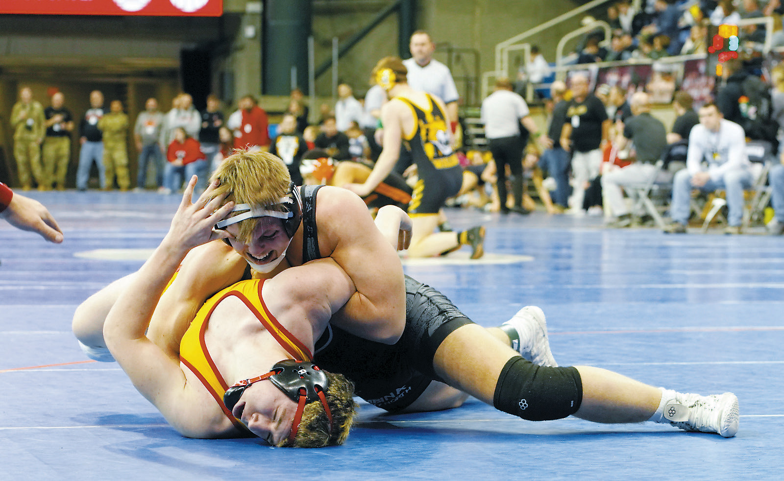 Gavin Symington wraps up his opponent in the 189 lbs. weight class. Photo by Larry Stokke.