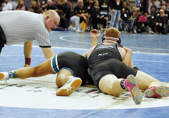 Kaden Rose pins his man in one minute 11 seconds in the 215 lbs. weight class. Photo by Larry Stokke.