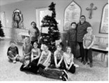 Mrs. Logie’s third grade class decorates a Christmas tree ahead of the holiday. Submitted photo