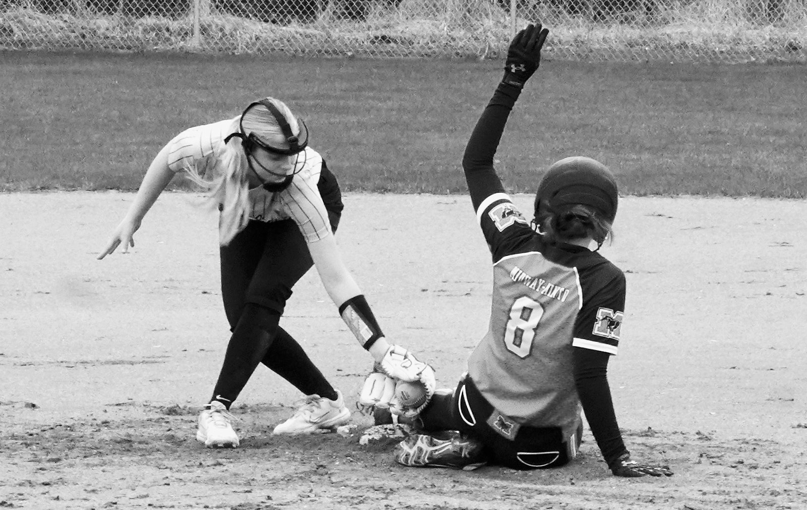 Pembina County North player Hannah Russell tags out a base runner in Minto on May 1. Photo by Larry Stokke.