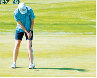 North Border Eagles golfer Bjorn Evenson lines up a putt during the North Dakota State Golf Tournament on June 2. Photo by Larry Stokke