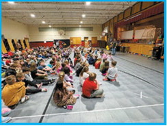 Students gather to learn about being a snowplow driver and get safety tips. Submitted photo.