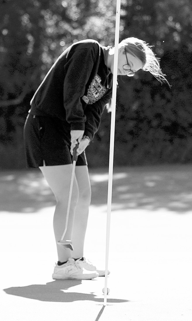 Nadia Lewis sinks a putt on her way to a seventh-place finish with a score of 97, helping the Cardinals secure second place as a team. Photo by Larry Stokke.