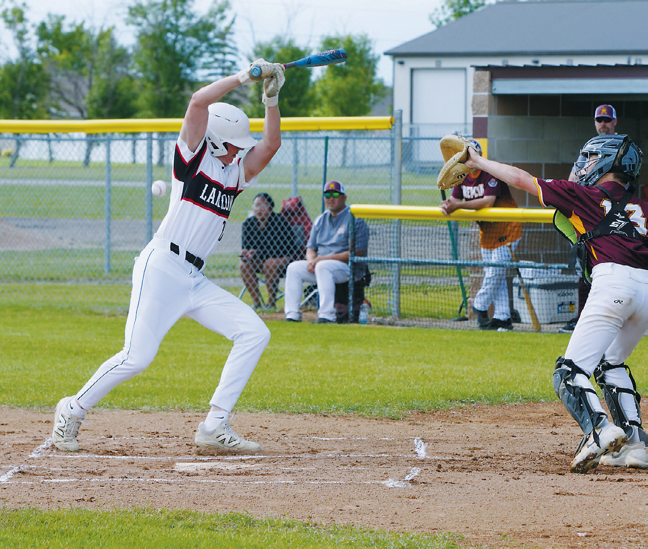 Austin Wenzel takes first base after being hit by a pitch during Langdon's game against Grafton. Photo by Larry Stokke