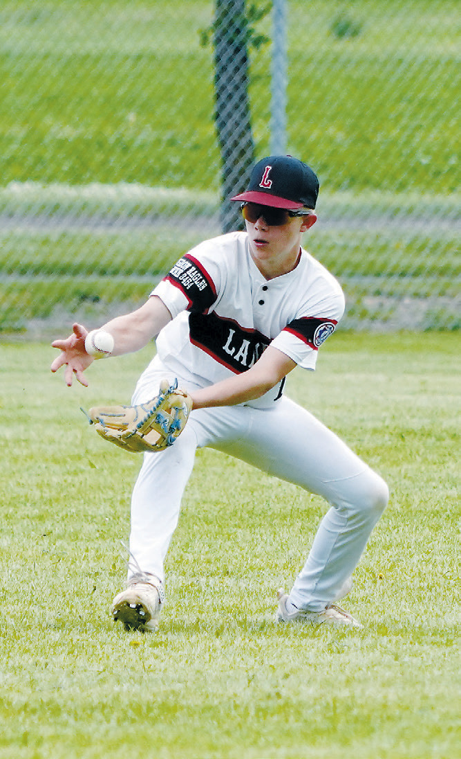 Max Mostad makes a catch in center field for an out during Langdon's game against Grafton. Photo by Larry Stokke