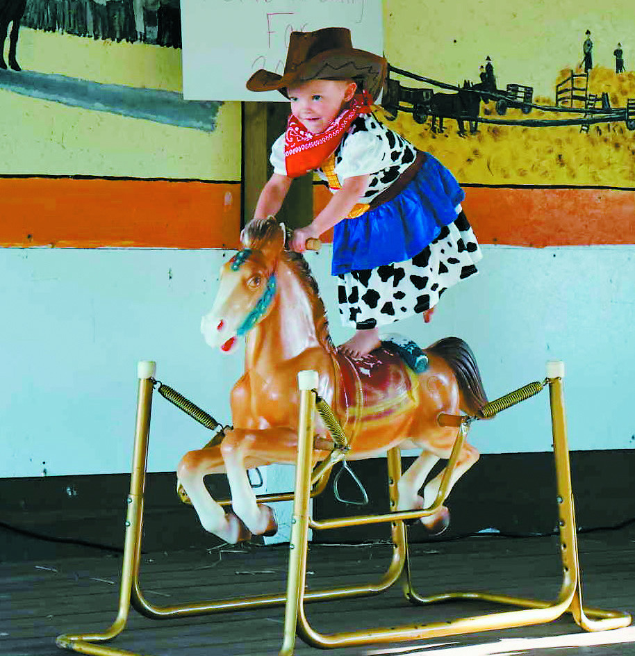Kyah Sharp showcasing her talent by riding her rocking horse. Photo by Rebecca Davis.