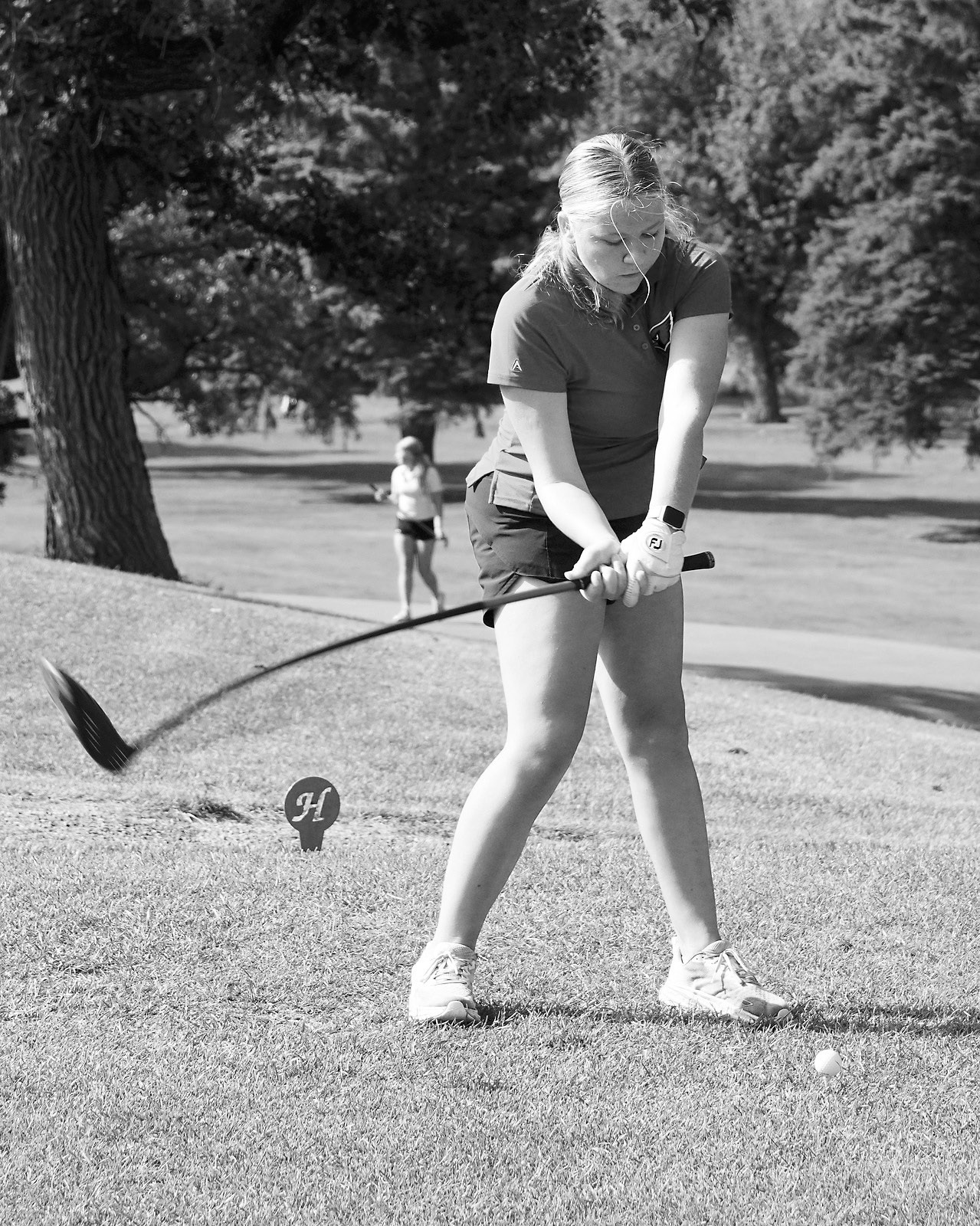 Colby Forest puts a little bend in her club as she tees off. Photo by Larry Stokke.