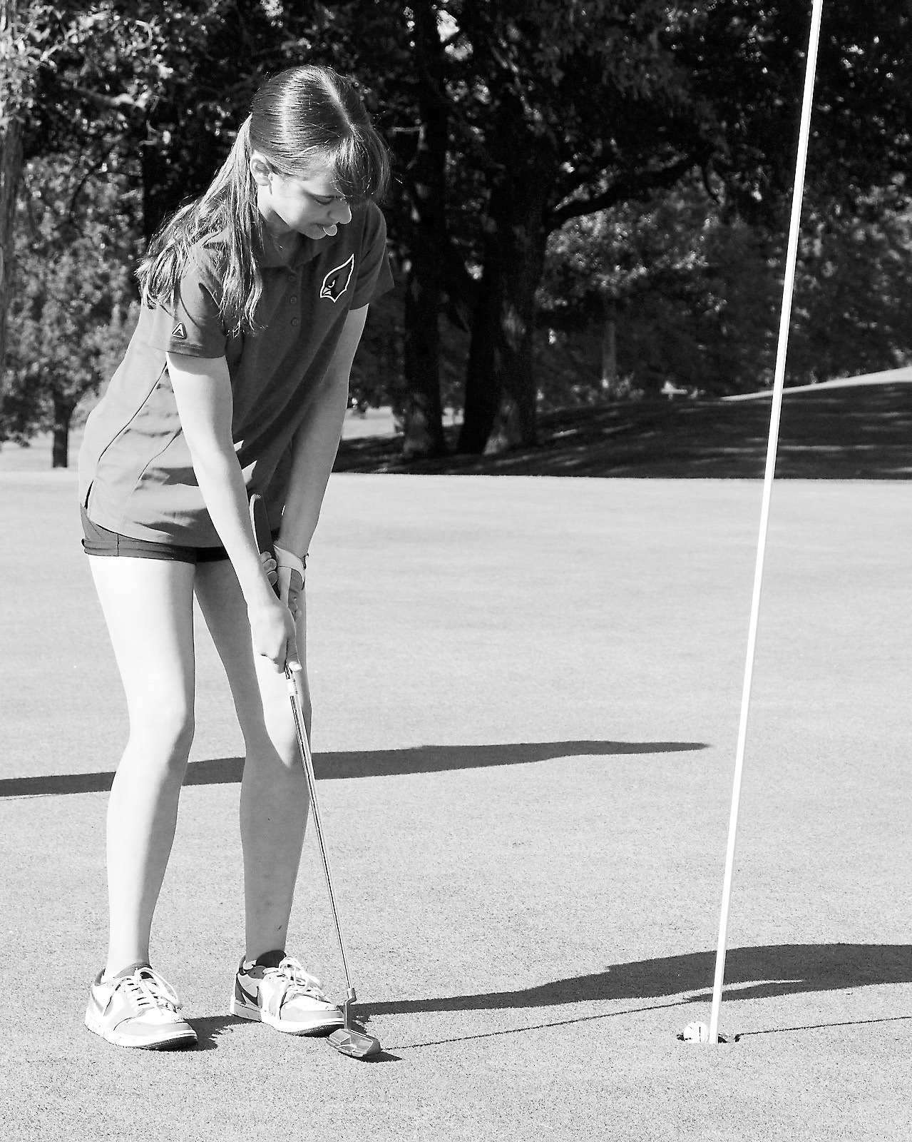 Lily Zimmer drops the ball into the cup at the Park River Meet on Aug. 14 and finished with a score of 103. Photo by Larry Stokke.