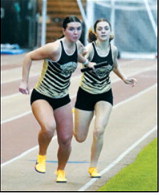 Shirley Kemp hands the baton to Delaney Denault. Teammates were Maci Puppe and Emersen Helgoe. They ran a very close race and finished second in the 4x400. Photo by Larry Stokke