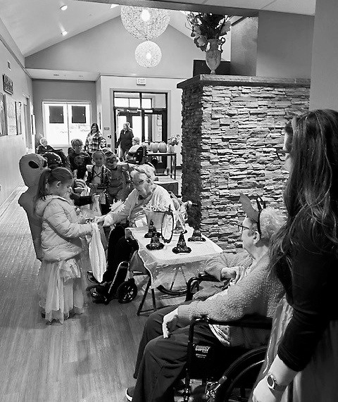 Gerry and Darlene passing out candy to trick-or-treaters.