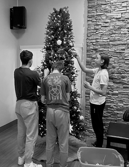 Chris, Dylan, and Zander decorating one of the trees at PNC.