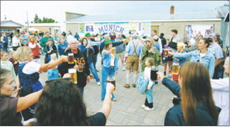 Festival-goers raise their mugs for a community toast during Munich’s annual Oktoberfest celebration. Photo by Larry Stokke