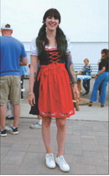 An Oktoberfest attendee embraces the celebration’s German theme by wearing a traditional dirndl dress. Photo by Larry Stokke