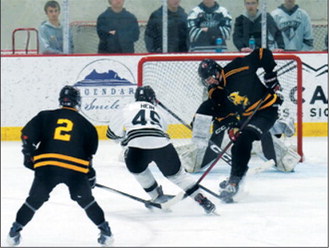 Colten Hein drives in and fires a shot at the net. Photo by Larry Stokke