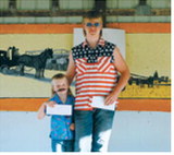 L-R: Mickane Halverson, first place, and Chaz Halverson, second place, pose with their awards following the Pembina County Fair Mullet Contest. Photo by Larry Stokke