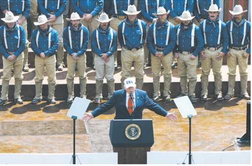 President Donald Trump speaks to a crowd July 1, 2026, at the Burning Hills Amphitheatre in Medora, N.D., in front of people portraying Theodore Roosevelt’s Rough Riders. (Photo by Kyle Martin/For the North Dakota Monitor)