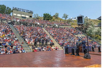 A crowd fills the Burning Hills Amphitheatre July 1, 2026, in Medora, N.D. The crowd listens to introductory remarks before President Donald Trump takes the stage. (Photo courtesy of North Dakota Governor’s Office)