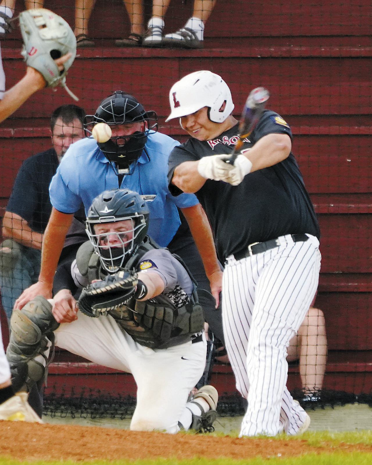 Cole Welsh drives the ball into the outfield against Miday/Minto. Photo by Larry Stokke.