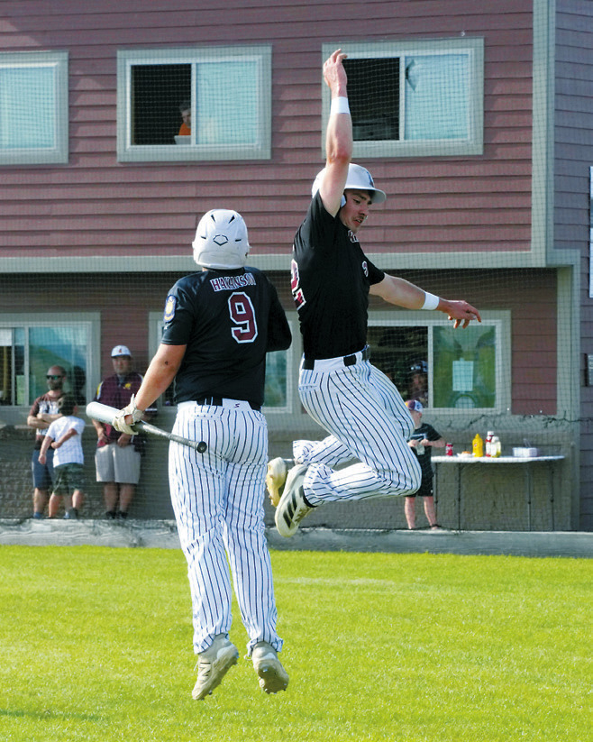 Mason Romfo celebrates with Devin Hakanson after he batted for the cycle. Photo by Larry Stokke.